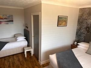 Postel nebo postele na pokoji v ubytování Braeburn Guesthouse