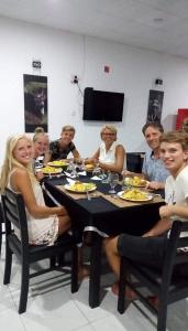 a group of people sitting around a table eating at Wild natural safari bunglow in Udawalawe