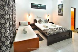 a bedroom with two beds in a room at Wild natural safari bunglow in Udawalawe