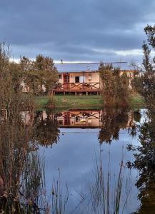 a house sitting on the side of a lake at Casa en Dalcahue - Mira Mar in Dalcahue
