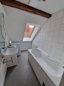 a bathroom with a white tub and a sink at Casa di Giovanni - Österreich in Frohnleiten