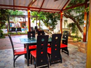 a table and chairs on a patio at Villa Cabana Inn in Playa Dormida