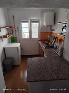a small kitchen with a sink and a microwave at MALUAN in Conil de la Frontera +9 photos