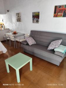 a living room with a couch and a table at MALUAN in Conil de la Frontera