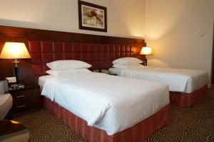 A bed or beds in a room at Grand Central Hotel