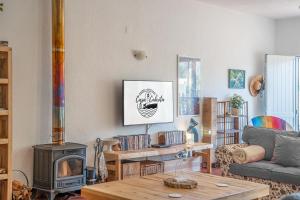 a living room with a couch and a wood stove at Casa Cabrita - Surf & Family House in Sagres in Sagres