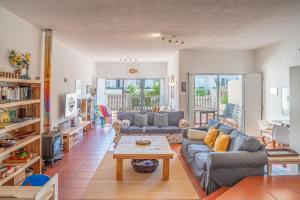 a living room with a couch and a table at Casa Cabrita - Surf & Family House in Sagres in Sagres