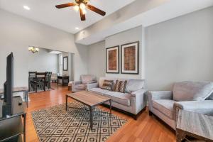 a living room with a couch and a table at St Louis Tower Grove Two-Story Townhome Perfect for Groups Side B in Tower Grove