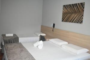 Una cama o camas en una habitación de Unity Hotel - Votorantim - SP