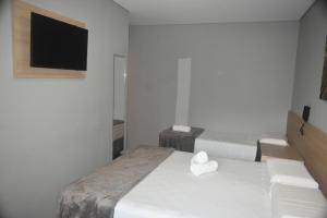 Una cama o camas en una habitación de Unity Hotel - Votorantim - SP