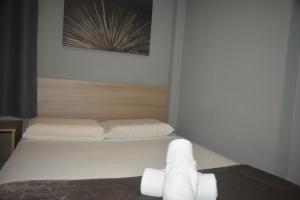 Una cama o camas en una habitación de Unity Hotel - Votorantim - SP