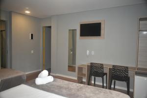 Una cama o camas en una habitación de Unity Hotel - Votorantim - SP