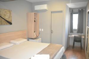 Un pat sau paturi într-o cameră la Unity Hotel - Votorantim - SP