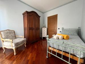 een slaapkamer met een bed, een stoel en een dressoir bij Tempio del Sole in Terni