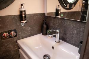 a bathroom with a sink and a mirror at The Homeboat Company Sant'Elmo-Cagliari in Cagliari
