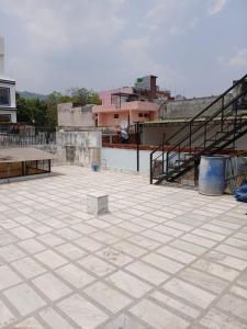 a large concrete patio with a staircase in the background at Haridwar Homestay in Haridwār