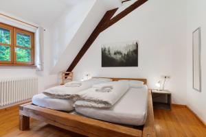 a bedroom with a large bed in a attic at Appartement Im Hof, 36qm in Schenkenzell
