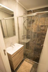a bathroom with a shower and a sink and a shower at Casa do Sol Nascente in Foz do Arelho +20 photos