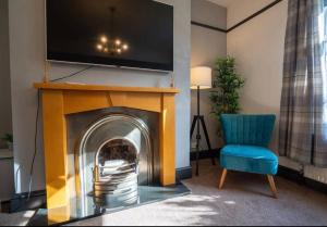 a living room with a fireplace with a tv above it at Spacious Town House in Lytham St Annes