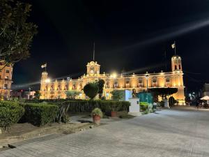 a large building with lights on it at night at Hotel El Mexicano Tepic Centro in Tepic