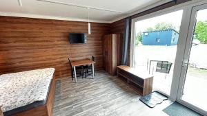 a bedroom with a bed and a desk and a table at Apartmány Štramberk in Štramberk