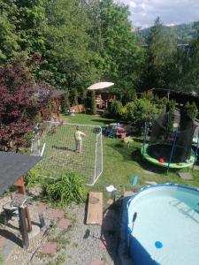 a boy is playing on a net in a backyard at Willa Na Górce in Szczyrk