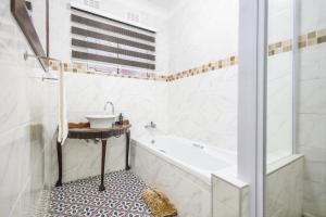 a bathroom with a tub and a sink at Safi Luxury Apartment 6 - 2 bedroom in East London