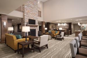 a lobby of a hotel with couches and chairs at Staybridge Suites Rehoboth Beach, an IHG Hotel in Lewes