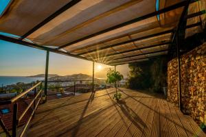 a wooden deck with a view of the ocean at Yoga House Kaş in Kaş