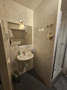 a bathroom with a sink and a shower at De Arcense Herberg in Arcen