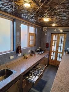 a kitchen with a sink and a counter top at Green House with kitchen in Srinagar