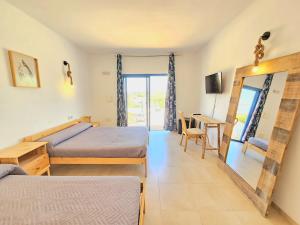 Postel nebo postele na pokoji v ubytování B&B La Nava Suites