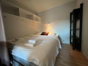 a bedroom with a bed with towels on it at Enter Backpack Hotel in Tromsø