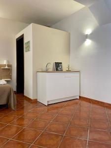 a room with a white cabinet and a tile floor at Dimora La Commare in Marsala