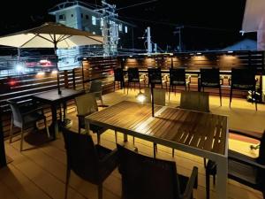 a table and chairs on a balcony at night at Guest house HaDuNo - Vacation STAY 85297v in Shingu