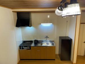 a kitchen with a sink and a stove at Guest house HaDuNo - Vacation STAY 85297v in Shingu