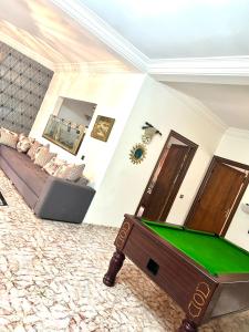 a living room with a pool table and a couch at Villa Naoual in Moulay Bousselham