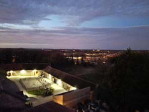 a building with a swimming pool at night at Chambres d'hôtes Provins in Poigny