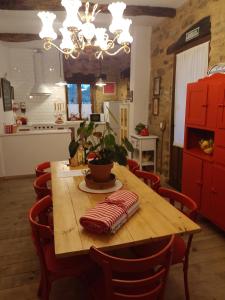 a kitchen with a wooden table and red cabinets at Casa rural Nica in Arganza