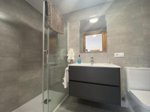 a bathroom with a shower and a sink and a toilet at Finca Robejones VV-511-AS in Colombres +41 photos
