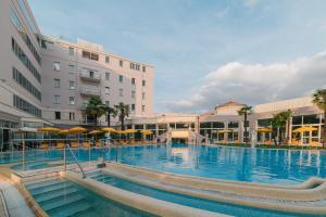 une grande piscine en face d'un bâtiment dans l'établissement Hotel Terme Helvetia, à Abano Terme