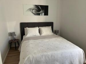 a bedroom with a bed with a black headboard at Apartments Mia in Bibinje
