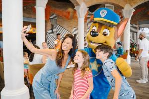 a woman and two children posing in front of a pokemon mascot at Nickelodeon Hotels & Resorts Punta Cana - Gourmet All Inclusive by Karisma in Punta Cana