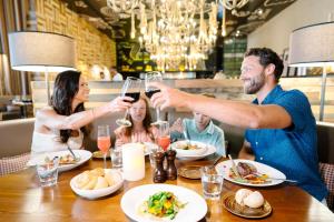 a group of people sitting around a table drinking wine at Nickelodeon Hotels & Resorts Punta Cana - Gourmet All Inclusive by Karisma in Punta Cana