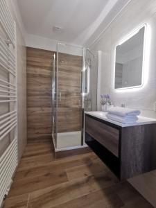 a bathroom with a shower and a sink at One1-Apartments in Kötschach