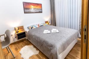 Postel nebo postele na pokoji v ubytování Apartman Kolarević