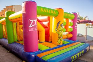 a inflatable bounce house in a playground at Apartamentos turísticos Jardines del Plaza in Peniscola