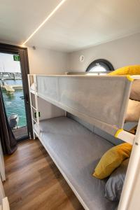 a room with two bunk beds in a boat at The Homeboat Company Sant'Elmo-Cagliari in Cagliari