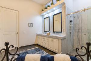 a bathroom with a sink and a mirror at Palacio Blanco Luxury Villa 3 in La Ventana +38 photos