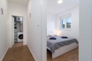 Postel nebo postele na pokoji v ubytování APARTMAN DINO